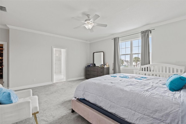 bedroom with crown molding, light colored carpet, ceiling fan, and connected bathroom