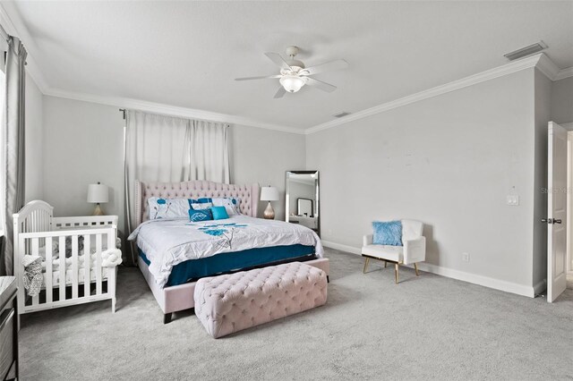 bedroom with carpet flooring, ceiling fan, and crown molding