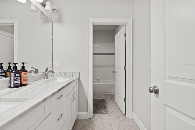 bathroom with tiled shower / bath and vanity