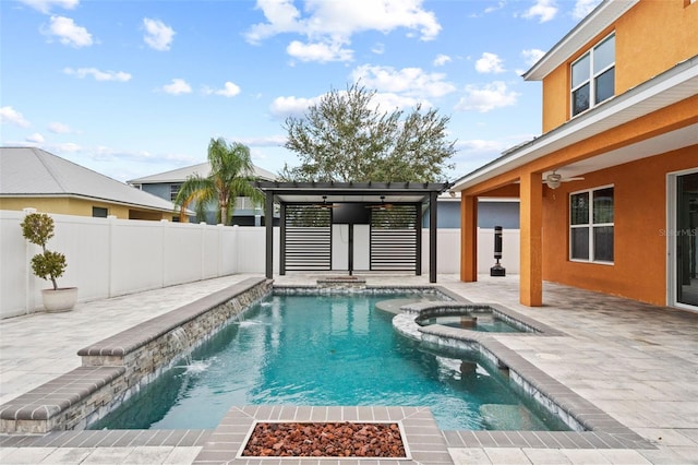 view of pool featuring an in ground hot tub, pool water feature, and a patio