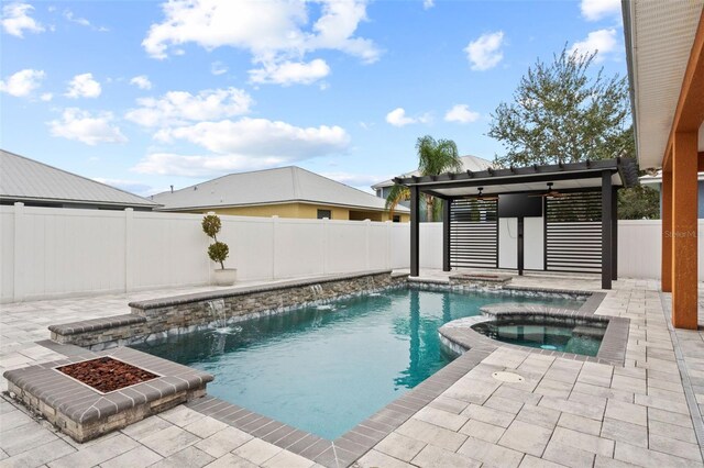 view of pool with an in ground hot tub, pool water feature, a pergola, and a patio area