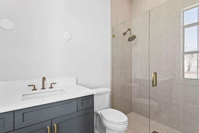 bathroom with vanity, a shower with shower door, and toilet