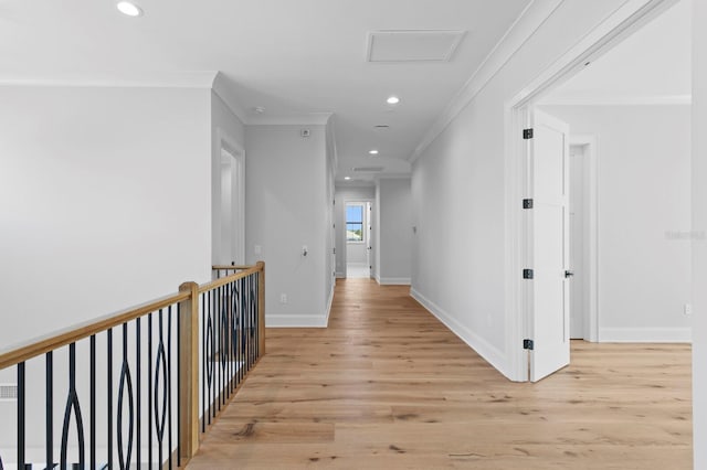 hallway with crown molding and light hardwood / wood-style flooring