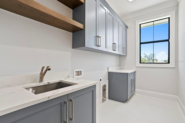 washroom with electric dryer hookup, sink, hookup for a washing machine, and cabinets