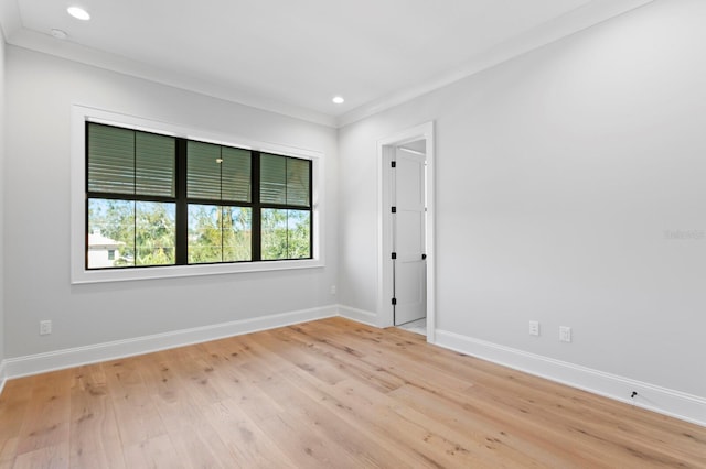 unfurnished room with crown molding and light hardwood / wood-style floors