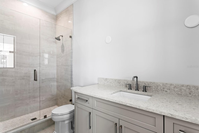 bathroom featuring vanity, toilet, and walk in shower
