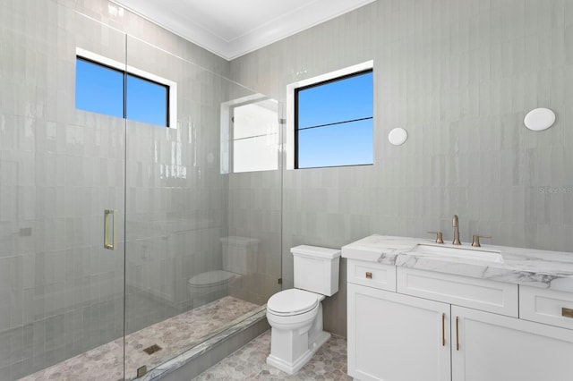 bathroom featuring tile walls, vanity, an enclosed shower, ornamental molding, and toilet