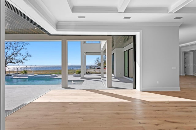 interior space with beamed ceiling, crown molding, and light hardwood / wood-style floors