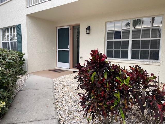 view of exterior entry with stucco siding