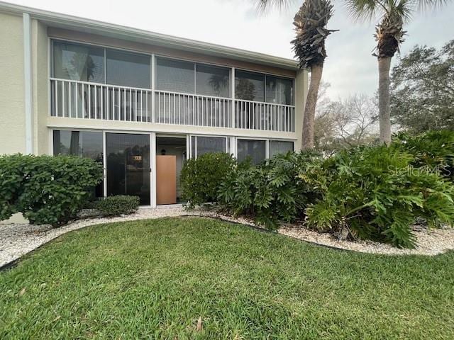 rear view of house featuring a yard