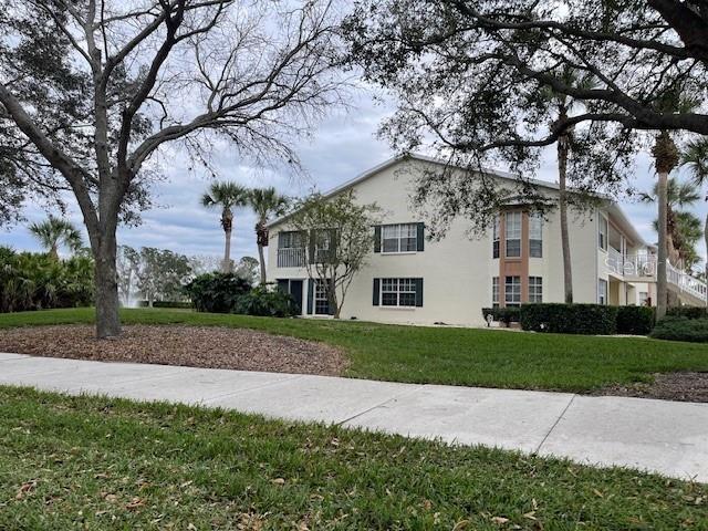 view of side of home with a lawn