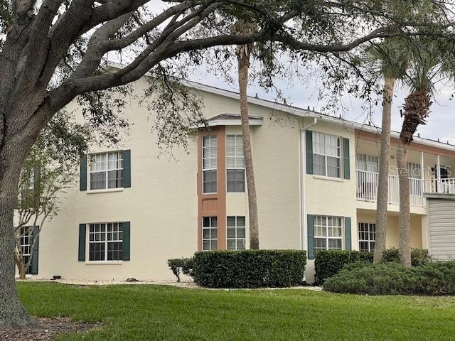 view of property exterior with a lawn