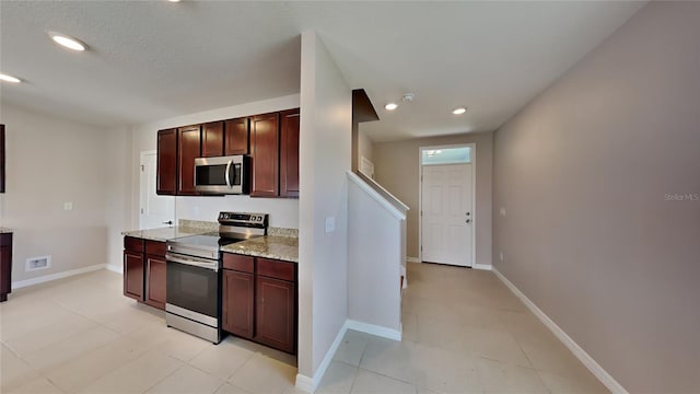 kitchen featuring light stone countertops and stainless steel appliances