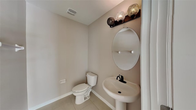 bathroom featuring tile patterned flooring, toilet, and sink