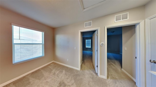 spare room featuring light colored carpet