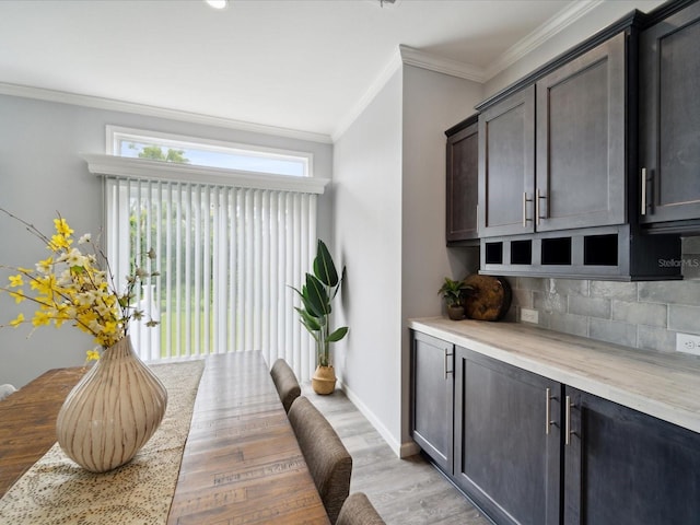 interior space with light hardwood / wood-style floors and ornamental molding