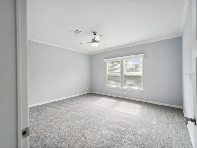 spare room with carpet floors, ceiling fan, and crown molding