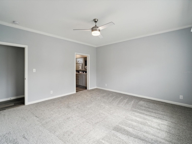 spare room with carpet, ceiling fan, and ornamental molding