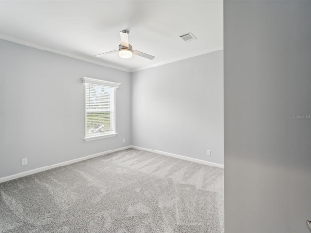 unfurnished room with carpet flooring, crown molding, and ceiling fan