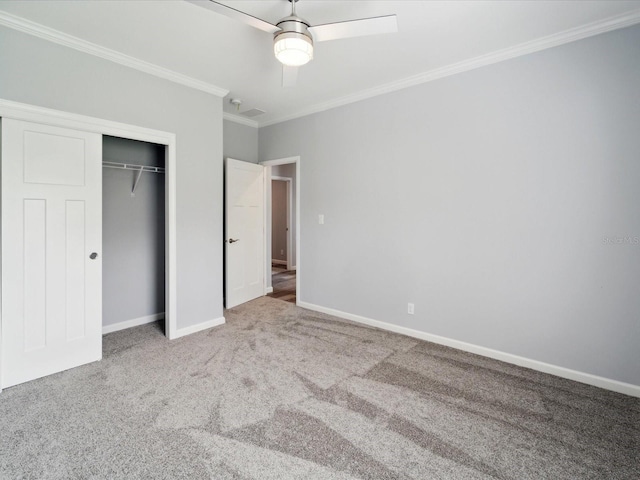 unfurnished bedroom with carpet flooring, ceiling fan, a closet, and ornamental molding