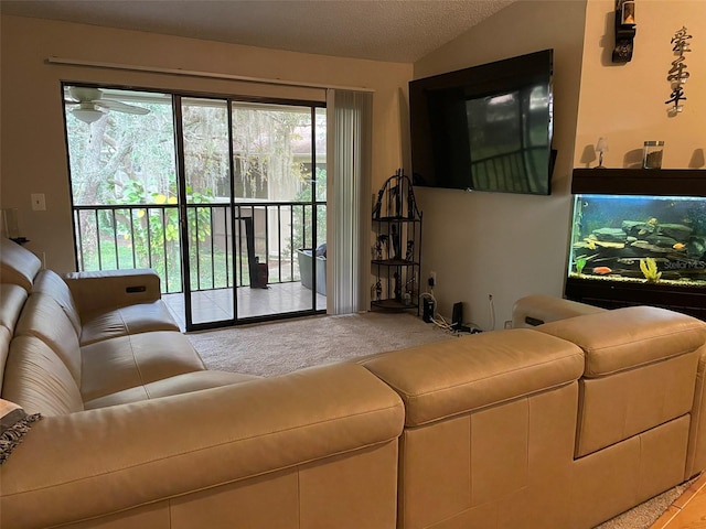 carpeted living room featuring plenty of natural light, ceiling fan, and vaulted ceiling