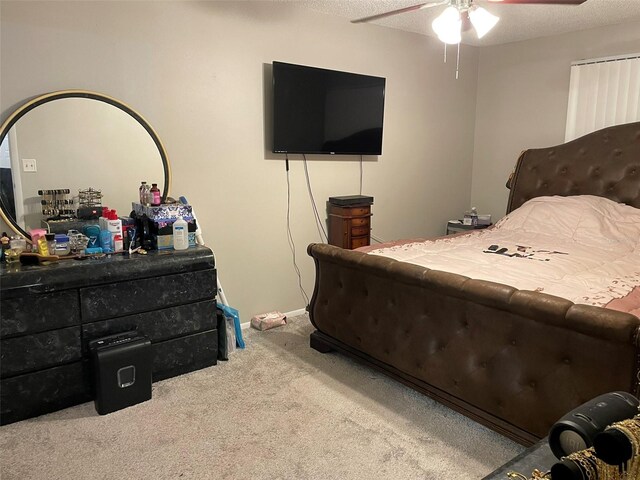 bedroom featuring a textured ceiling, carpet, and ceiling fan