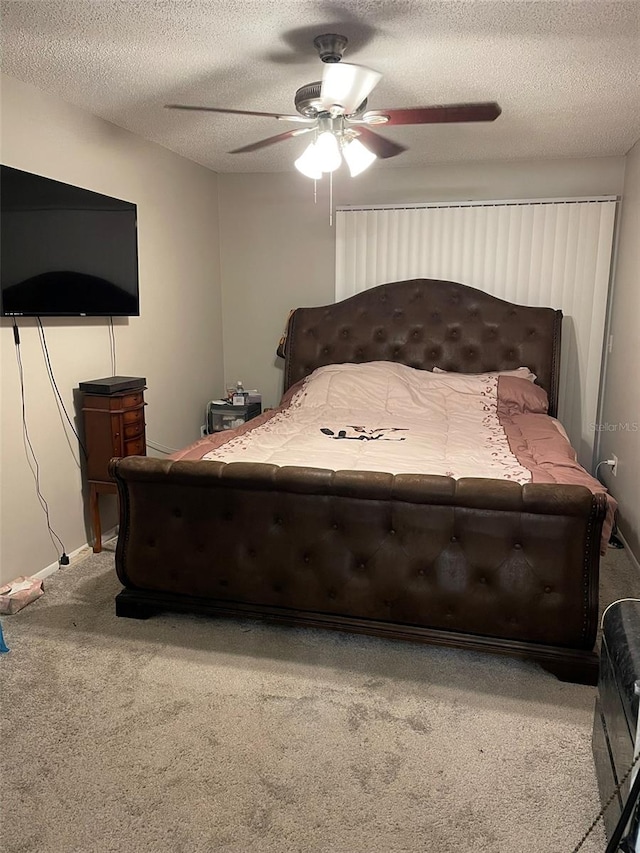 carpeted bedroom featuring a textured ceiling and ceiling fan