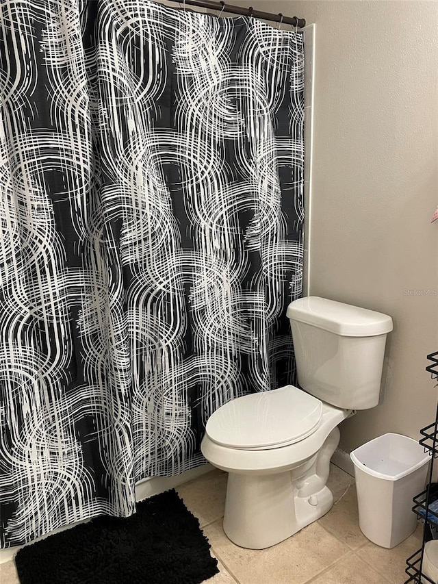 bathroom with tile patterned flooring and toilet