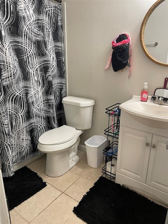 bathroom featuring vanity, tile patterned flooring, and toilet