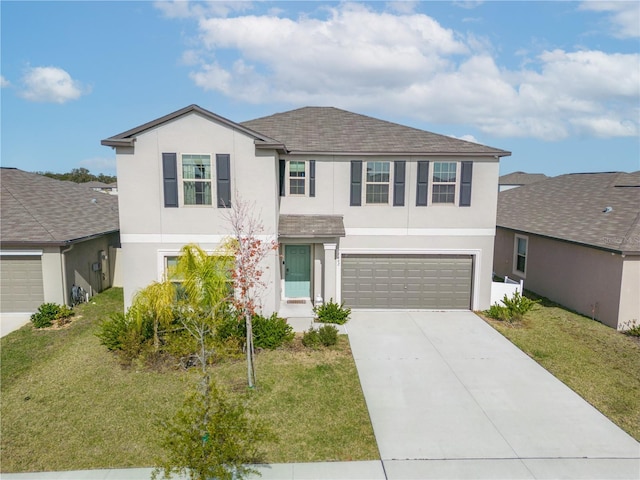 view of front of home with a front yard and a garage