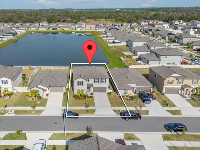 birds eye view of property with a water view