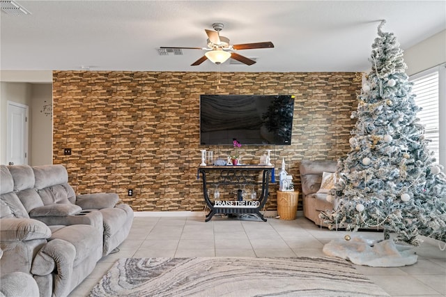 living room featuring ceiling fan and tile patterned flooring