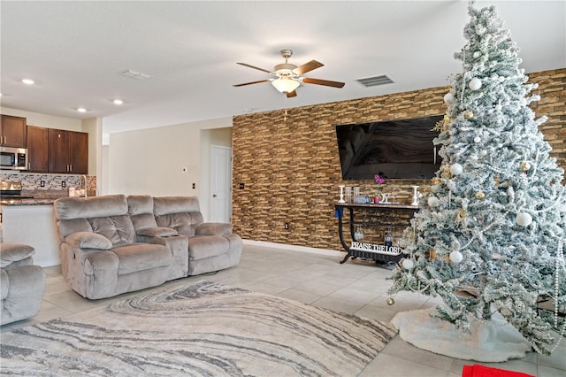 tiled living room with ceiling fan