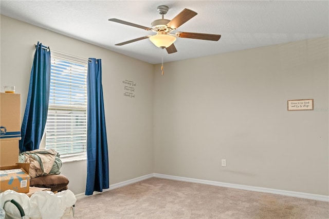 unfurnished room featuring ceiling fan and light colored carpet