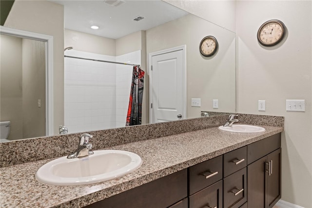 bathroom with vanity, toilet, and walk in shower