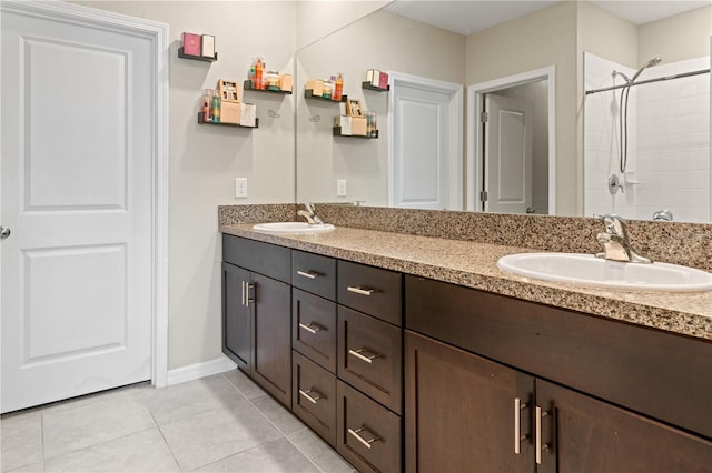 bathroom featuring tile patterned floors, vanity, and tiled shower