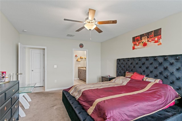 carpeted bedroom featuring ceiling fan and ensuite bath