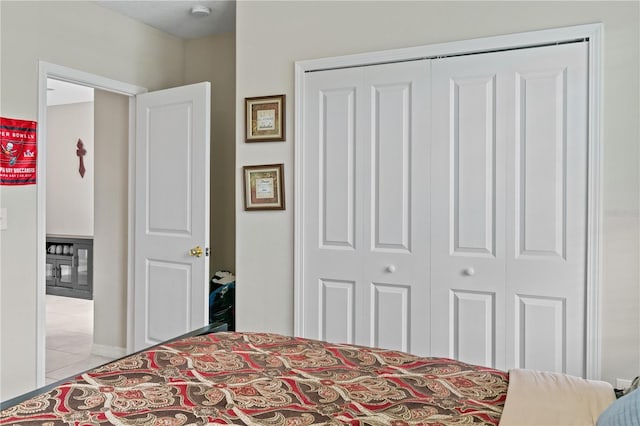 tiled bedroom featuring a closet