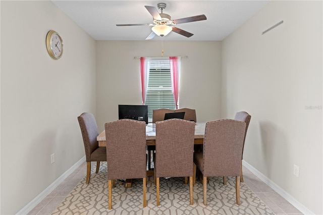 tiled dining space featuring ceiling fan