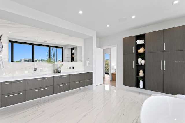 bathroom featuring backsplash, a tub to relax in, and vanity