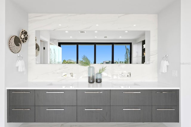 bathroom with vanity and decorative backsplash