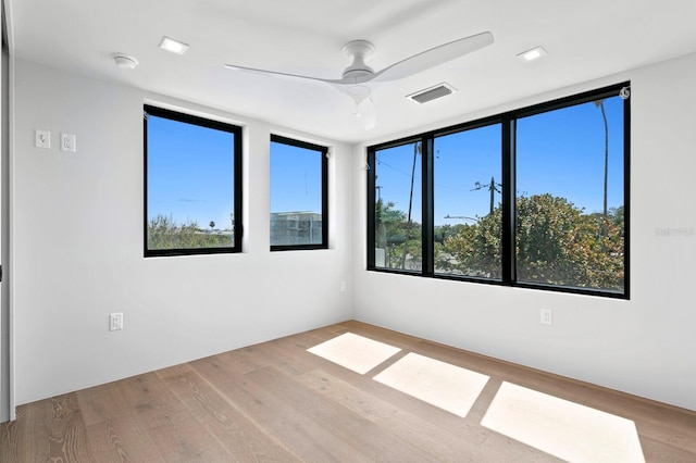 unfurnished room featuring ceiling fan and light hardwood / wood-style flooring