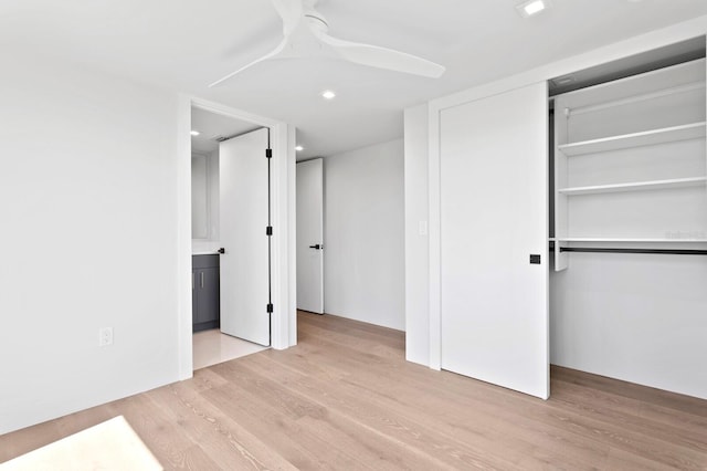 unfurnished bedroom with light wood-type flooring, a closet, and ceiling fan