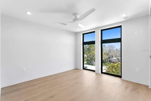 spare room featuring light hardwood / wood-style floors and ceiling fan