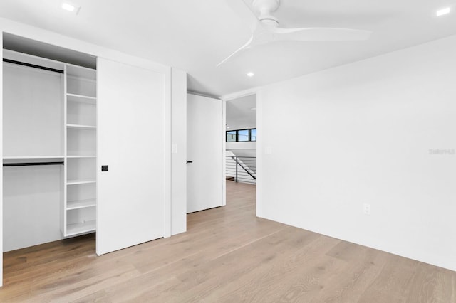 unfurnished bedroom with ceiling fan and light hardwood / wood-style floors