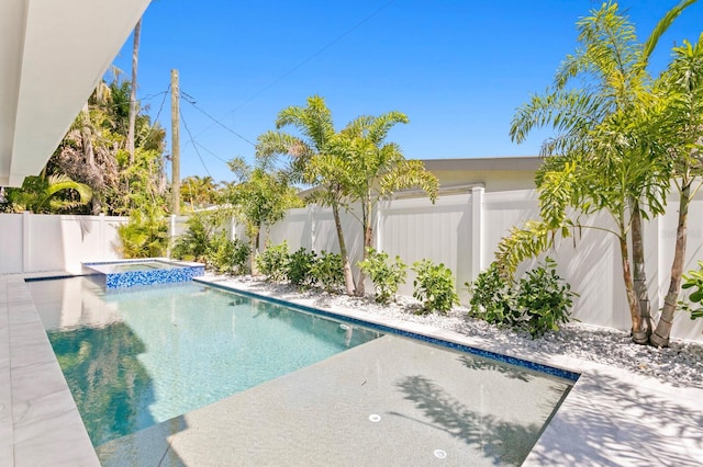 view of swimming pool with an in ground hot tub