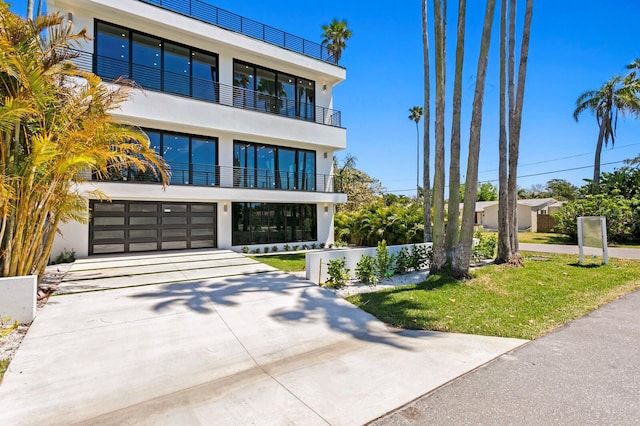 contemporary house with a garage and a front yard