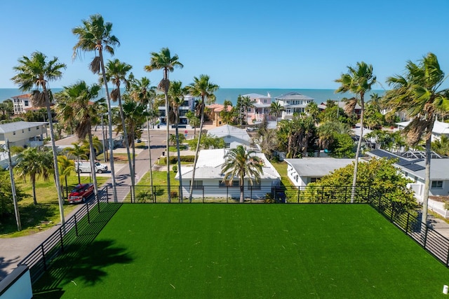 view of community featuring a water view and a yard