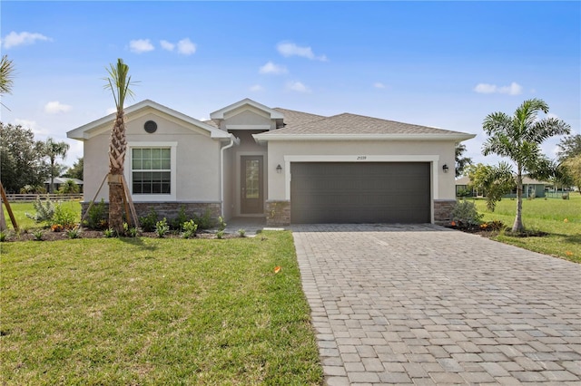 view of front of property with a front yard and a garage