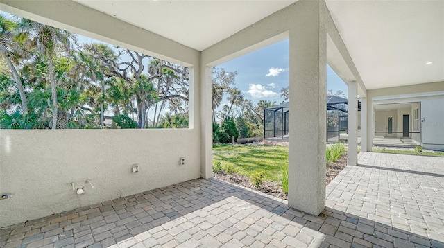 view of patio with glass enclosure